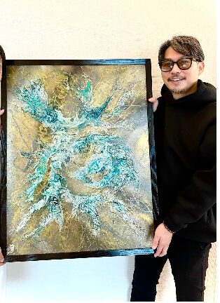 オーラアートと一緒に写る坂東工の画像